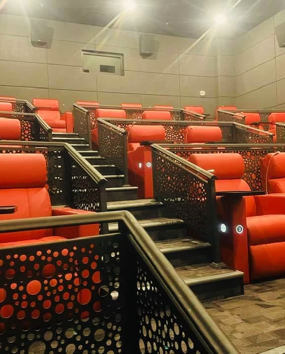 Cinema hall interior with tiered luxury seating